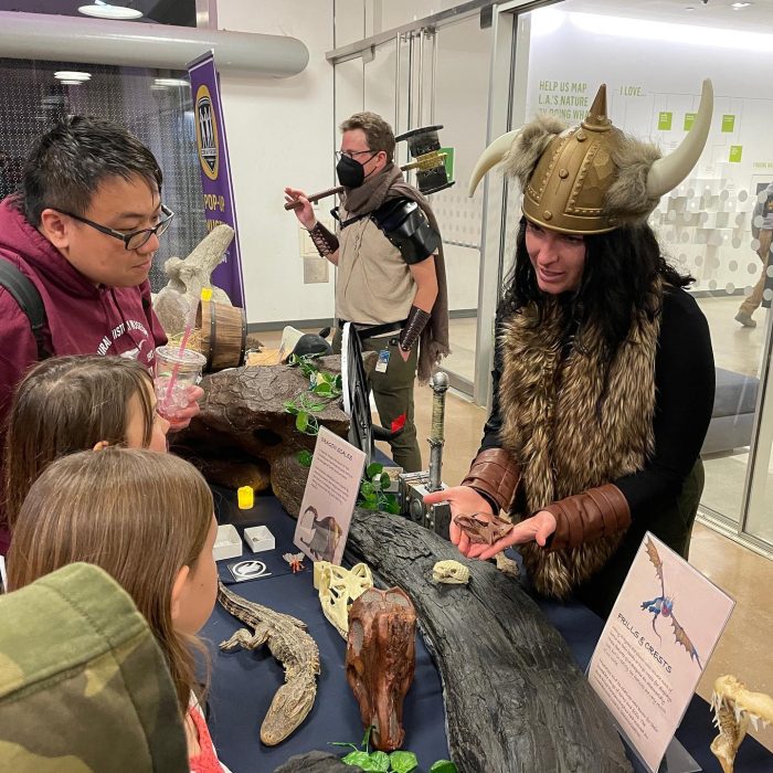 Kids and families learn about dinosaurs at a museum for a spring break bucket list idea when visiting Claremont.