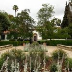 House surrounded by trees and beautiful plants. Revelle House, the presidents house, at Scripps College with "inscription walk" nearby full of famous women's quotes.