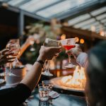 People toasting wine glasses at a party at Walter's Restaurant.